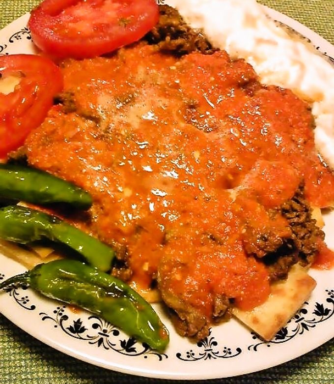 本格的なトルコ料理のイスケンデルケバブを準備するシェフPremium AI生成画像